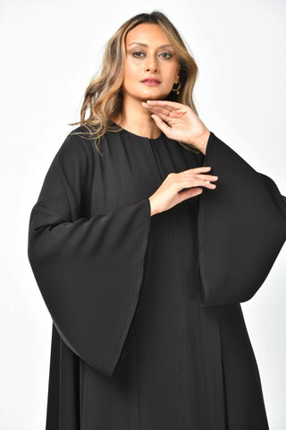 Plain, formal, triple-cloche abaya with vertical cuts from Tahani Boutique